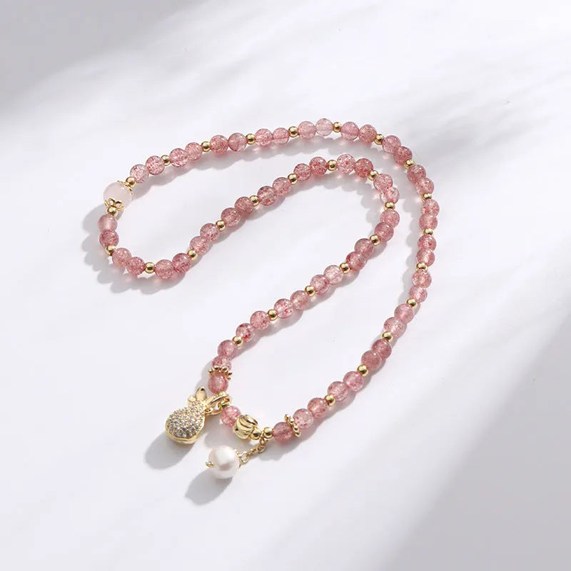 A geometric wallet bracelet for women made from pink strawberry quartz crystal.