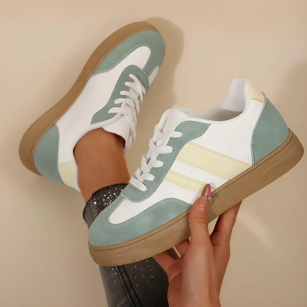 Green women's low-top retro sports shoes with cross straps and a flat rubber sole.