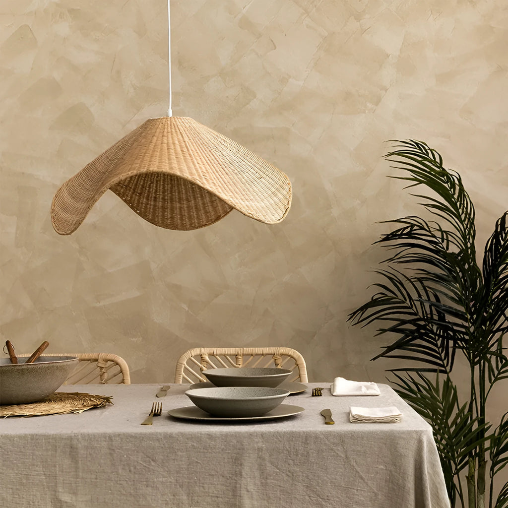 Handmade bamboo and straw rattan chandelier ceiling light with warm LED illumination in a rustic setting.