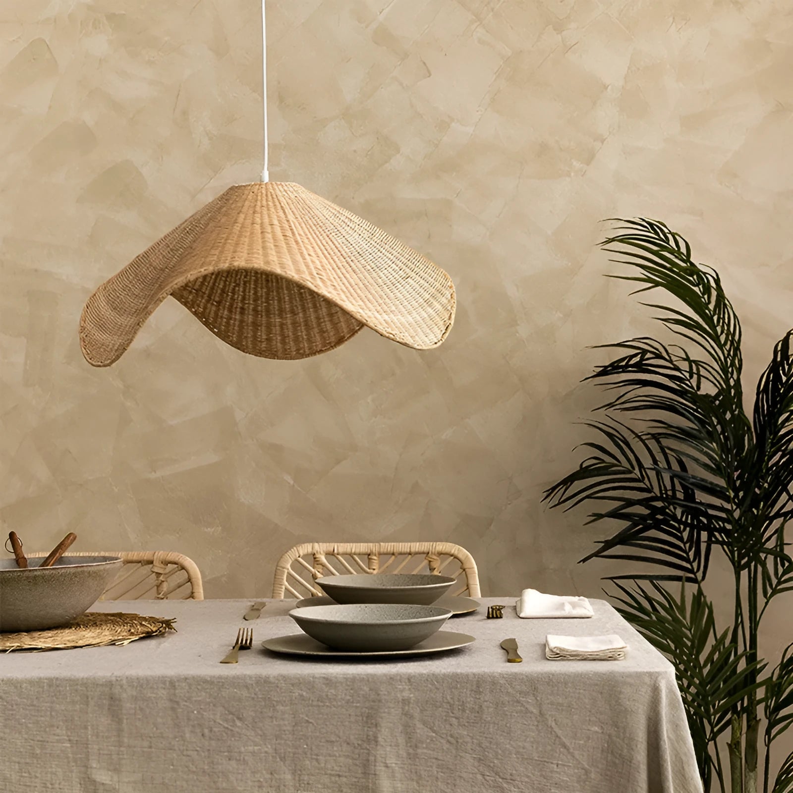 Handmade bamboo and straw rattan chandelier ceiling light with warm LED illumination in a rustic setting.