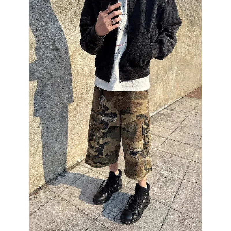 Men's camouflage cropped jeans with ripped detailing and retro patches in loose straight cut