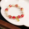 Gold foil coloured glaze ethnic bracelet with geometric Xingshi patterns and hanging gourd charms