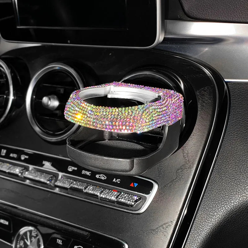 Rhinestone-encrusted white car cup holder bracket mounted on a vehicle air vent.