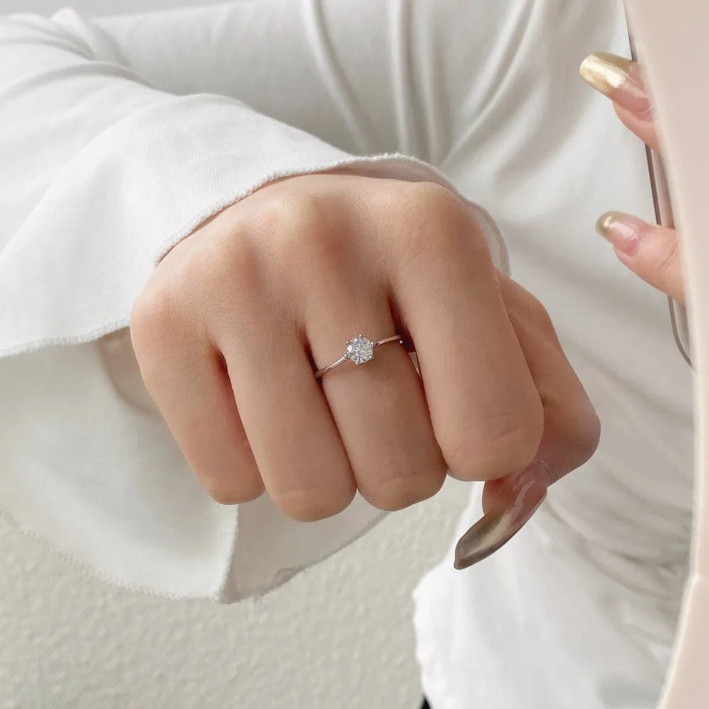 Sterling silver adjustable ring with round zircon in six-claw setting, open mouth band, geometric design