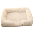 Round plush dog bed with raised rim and removable inner sleeve in beige brown colour