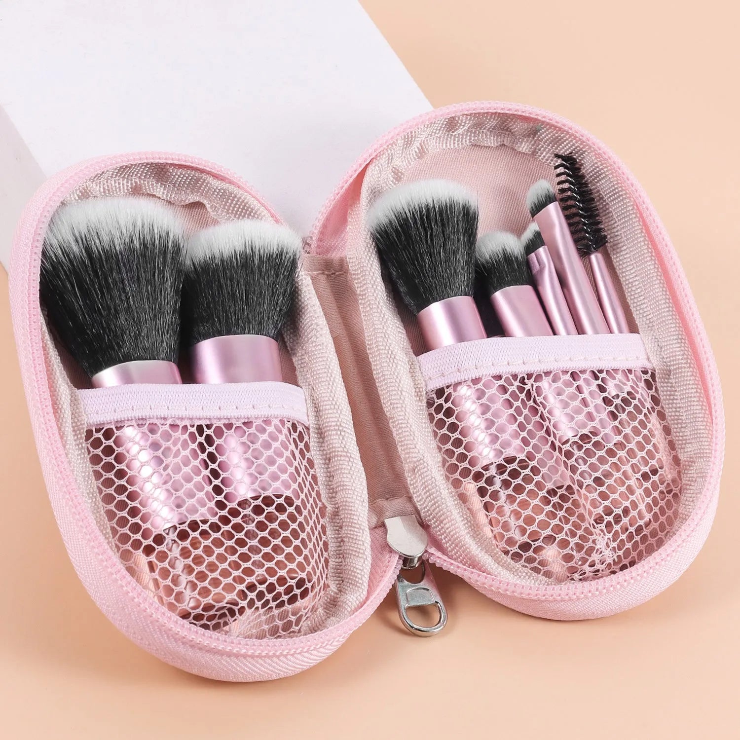 10-piece makeup brush set with crystal handles, aluminium tubes, and fibre bristles in a storage bag
