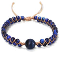 Handwoven geometric pull bracelet made with natural blue Tigereye stones on a wrist.