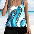 Blue tie-dyed floral patterned women's bikini swimsuit with separate top and shorts.