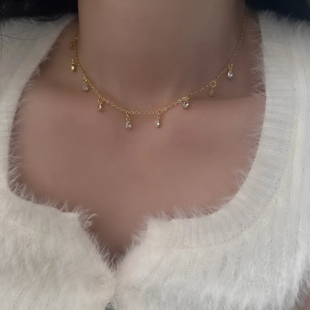 Zircon jewellery set with geometric necklace, matching earrings, and anklet.