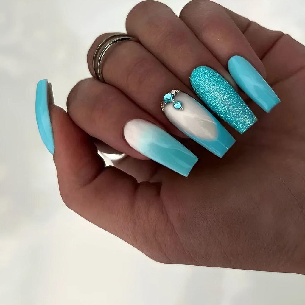 Long ballet style false nails with solid smart blue diamond colour and adhesive glue
