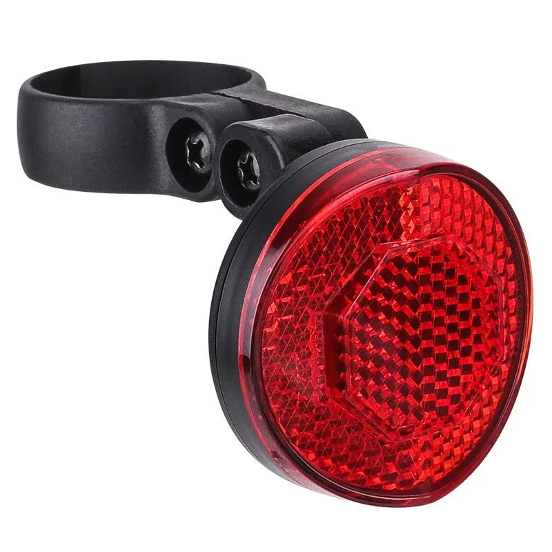 Red plastic anti-theft bicycle taillight bracket mounted on a bike seat post.