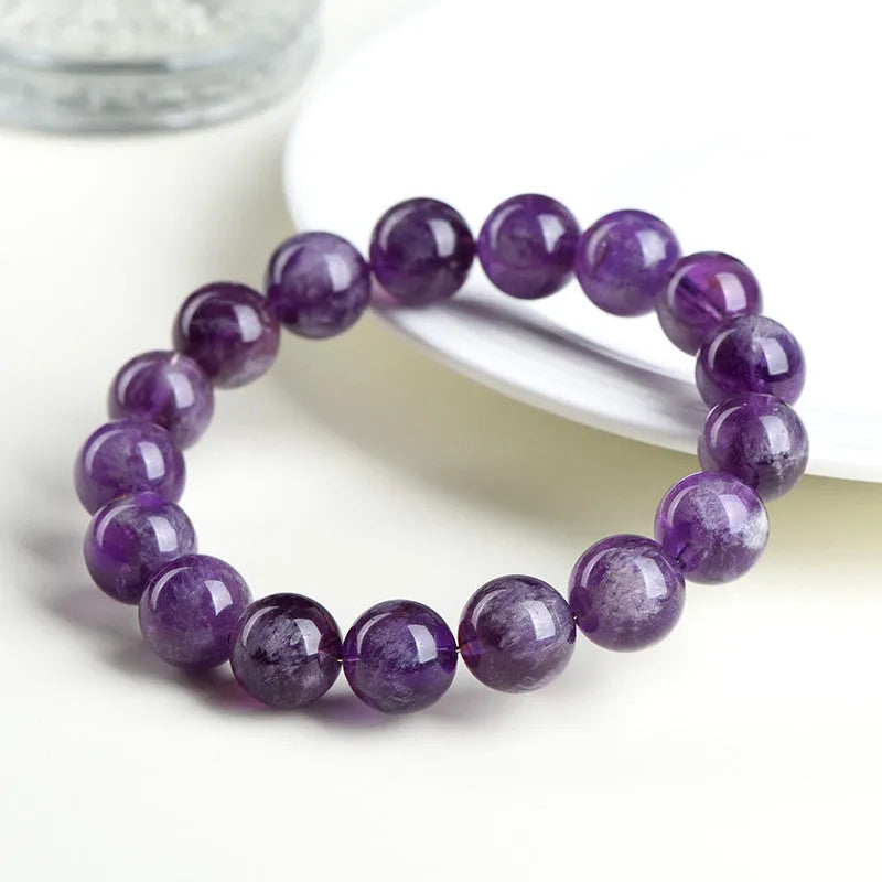 Natural feather amethyst crystal bracelet with geometric beads and Ruyi symbol in Snow Mountain purple.