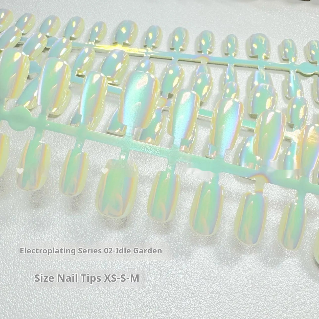 Set of false nails with electroplated cat's eye and aurora design on short ladder shaped tips.