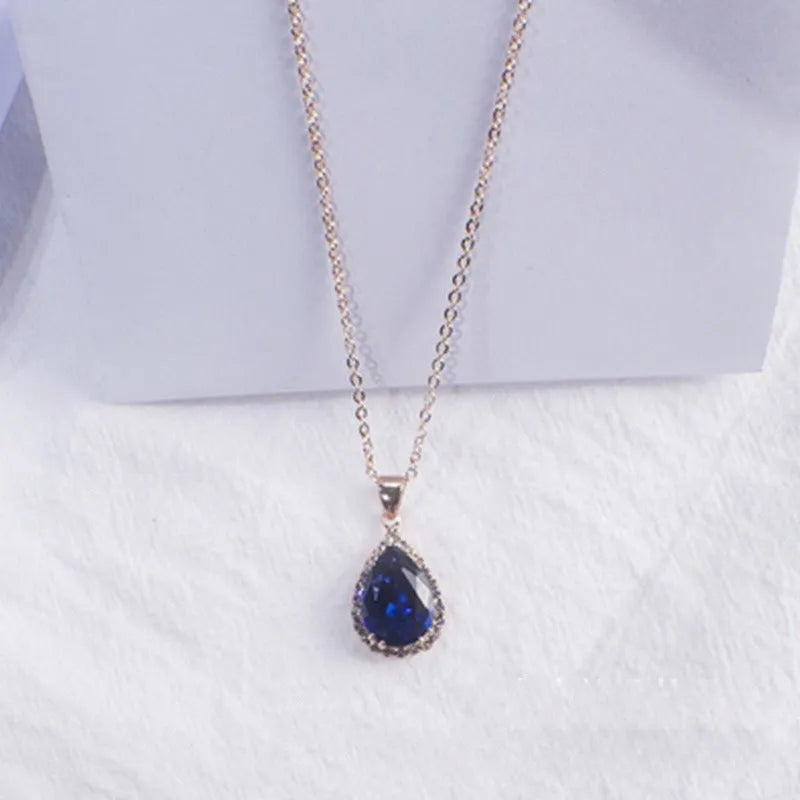 Women's water drop shaped pink necklace with rose gold rhinestone geometric detailing on alloy chain