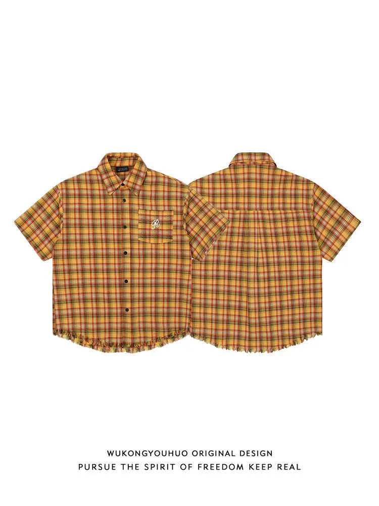 Yellow plaid short sleeve shirt with embroidered pocket detail and loose fit design