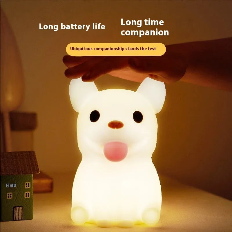 Silicone animal cartoon USB night light with Zodiac design on a bedside table.