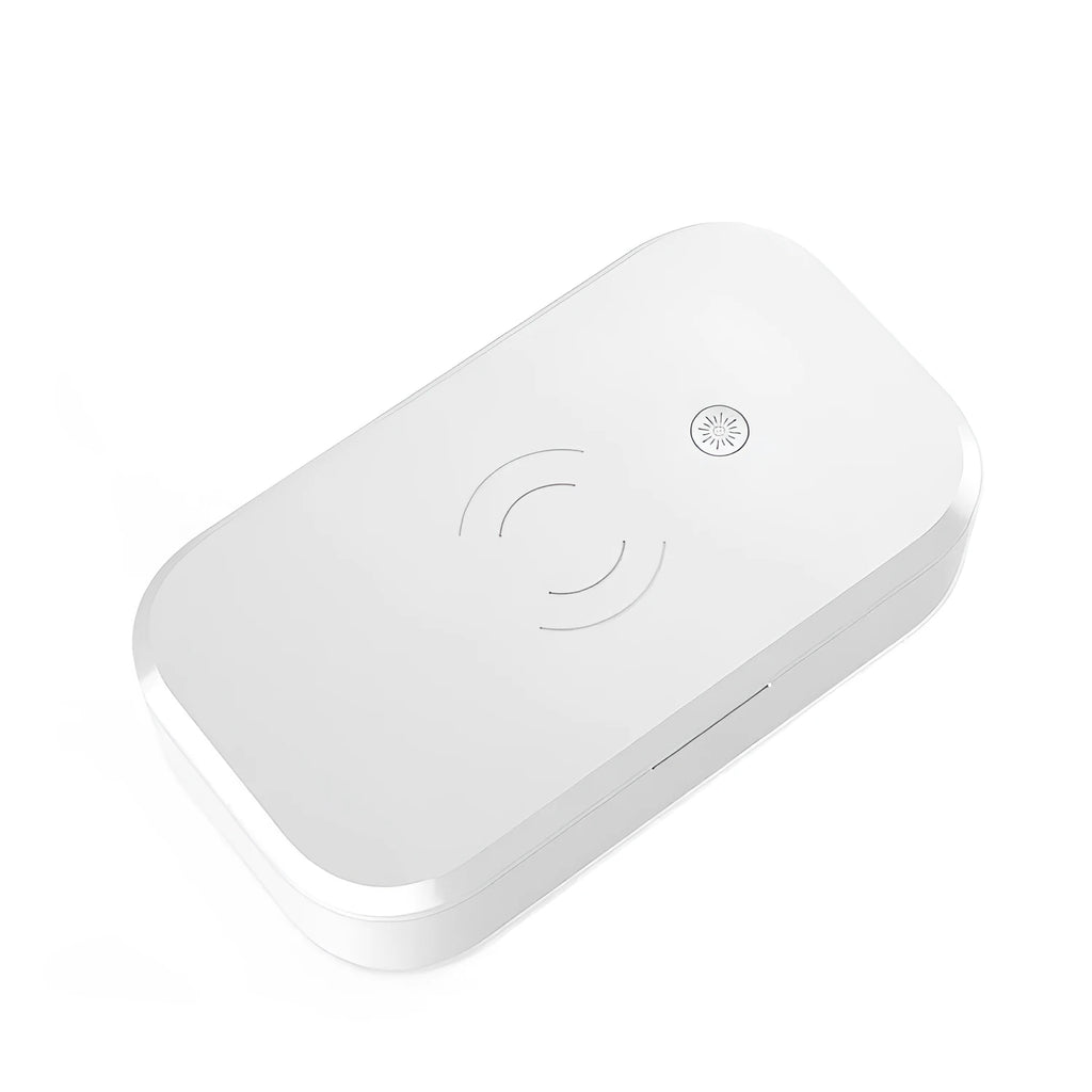 White UV disinfection box with wireless charging pad for mobile phones on top.