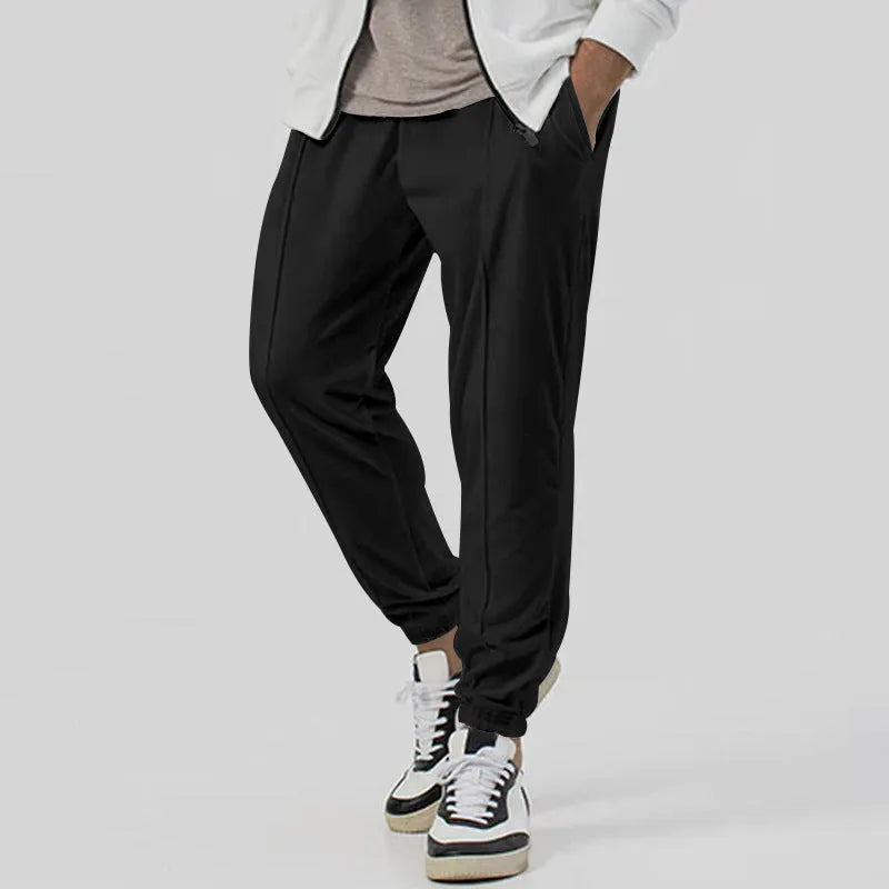 Men's grey straight-leg track sweatpants with a mid-waist, showcasing a relaxed fit and casual style.