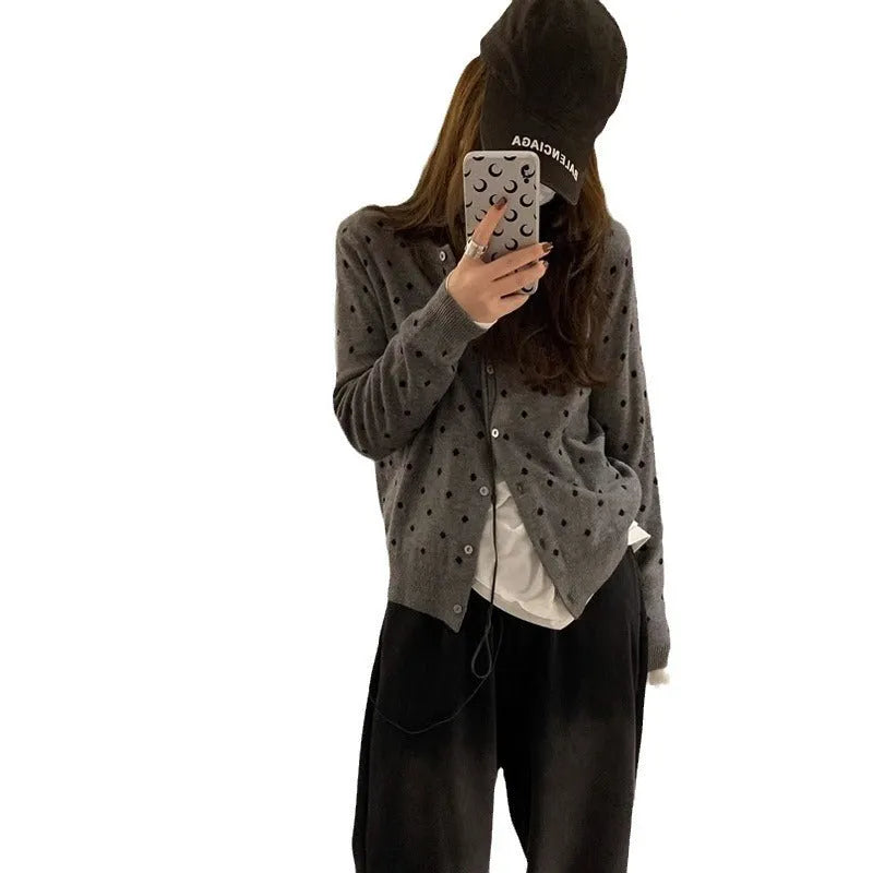 Women's grey dot pattern knitted cardigan with crochet flower detail, long sleeves, loose fit.