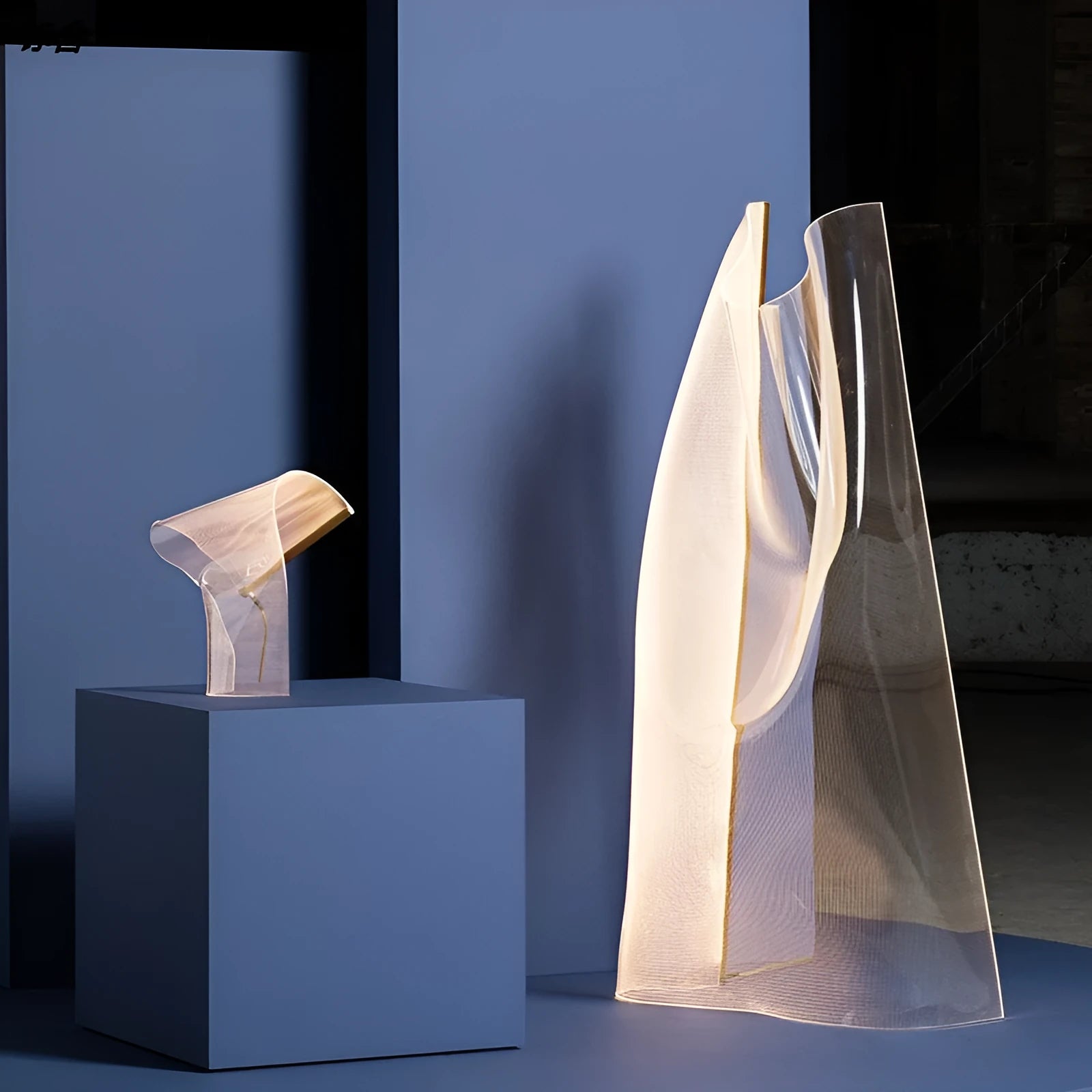 Irregular acrylic ribbon table lamp with warm light on a living room side table