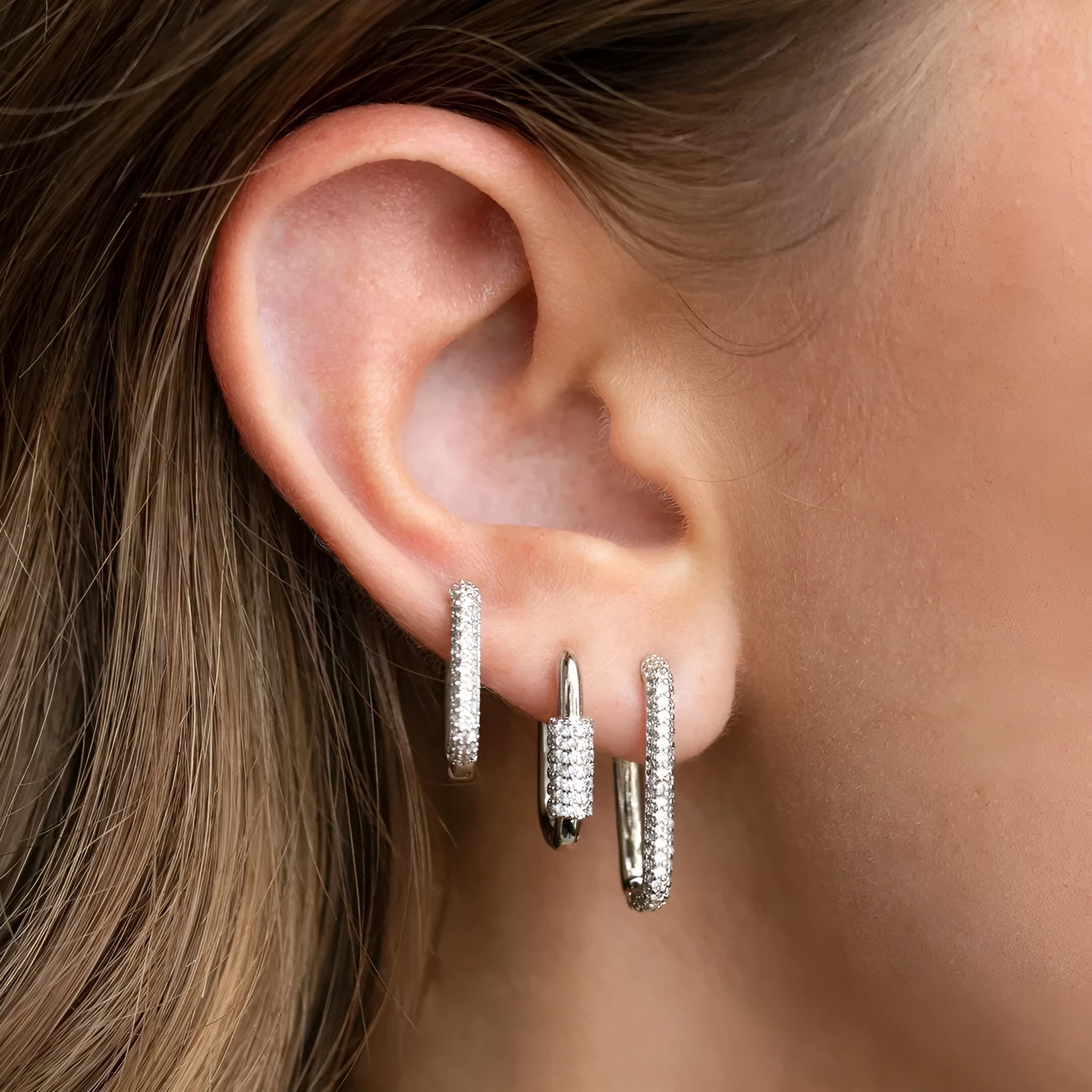 Geometric zircon ear clip set showing three square earrings with quadrilateral and ellipse designs