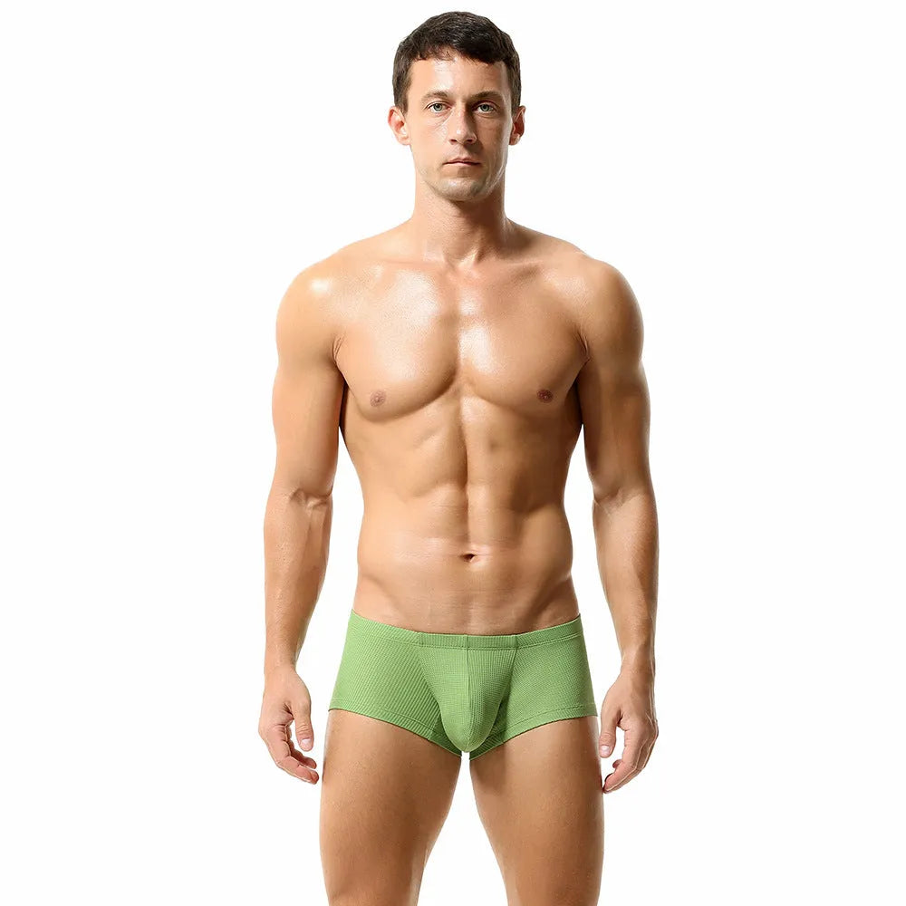 Men's low waist solid colour boxer shorts in breathable nylon fabric on a white background.