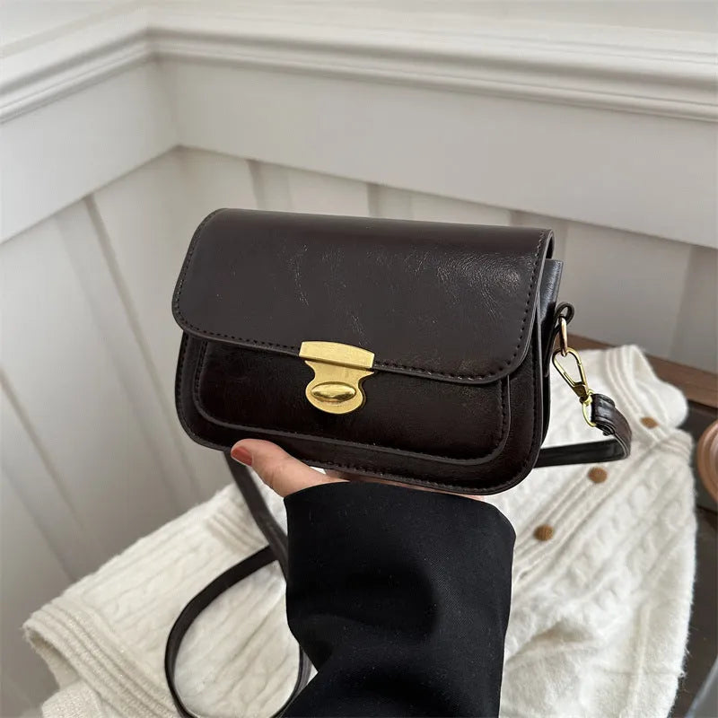 Small retro square shoulder bag in soft PU leather showing horizontal rectangular shape