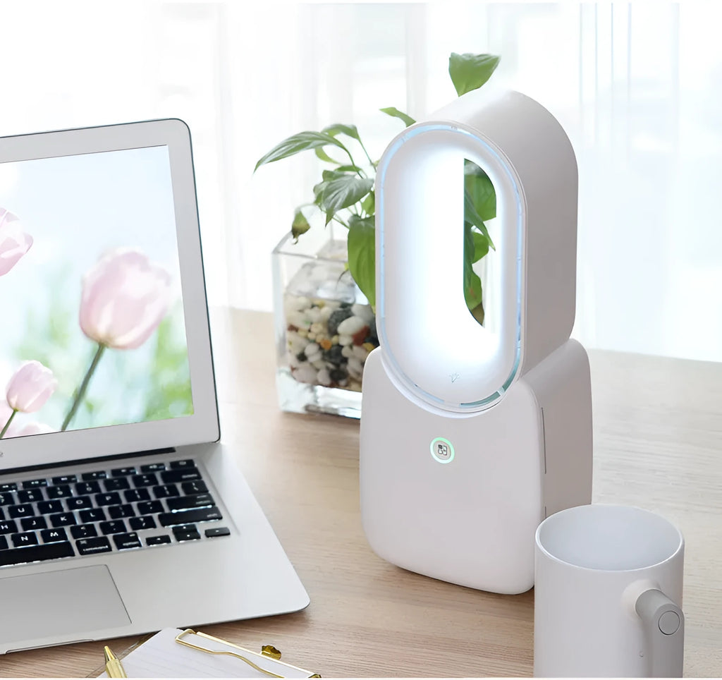 White USB charging portable mini bladeless fan with touch screen control on a desk
