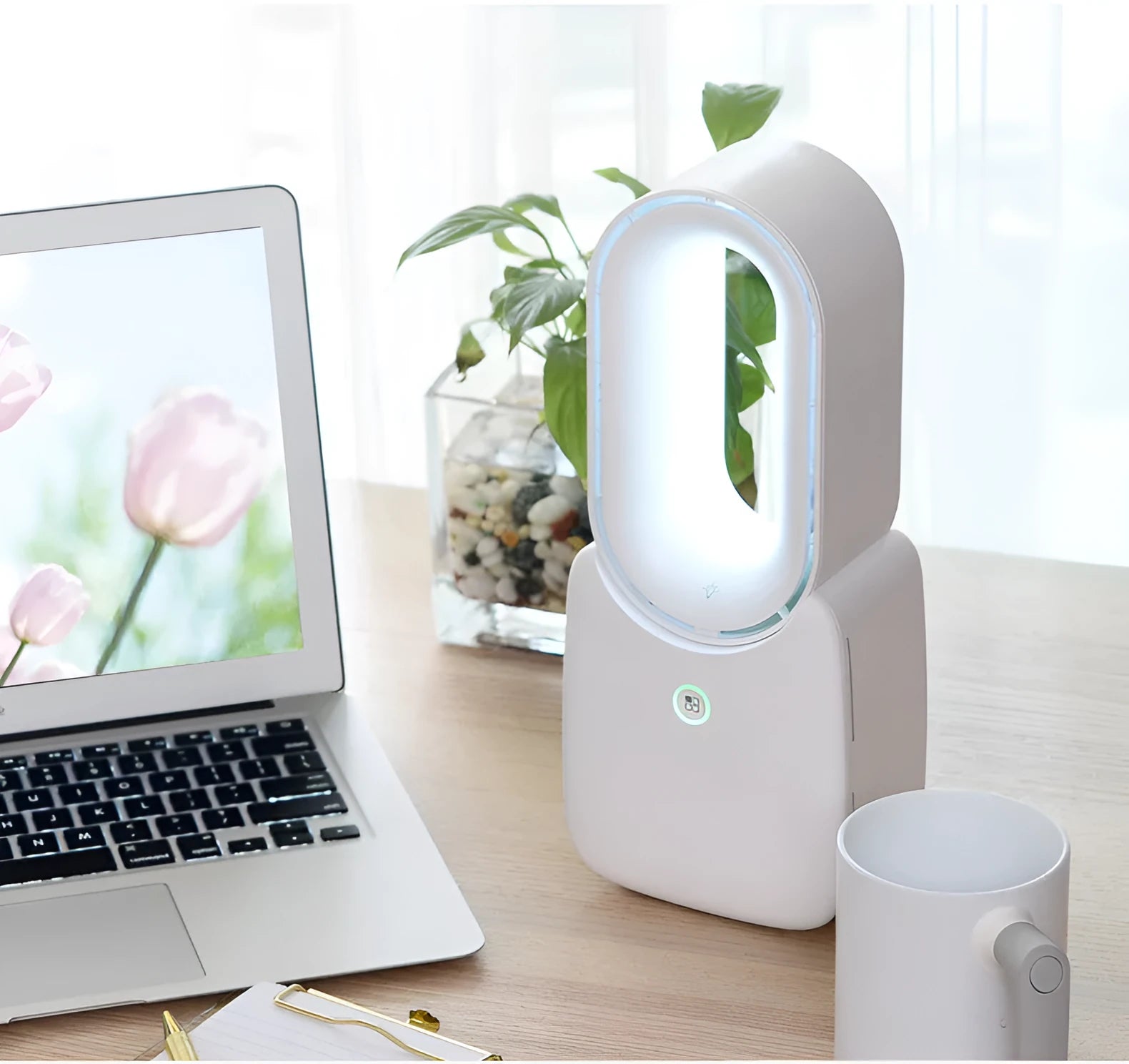 White USB charging portable mini bladeless fan with touch screen control on a desk