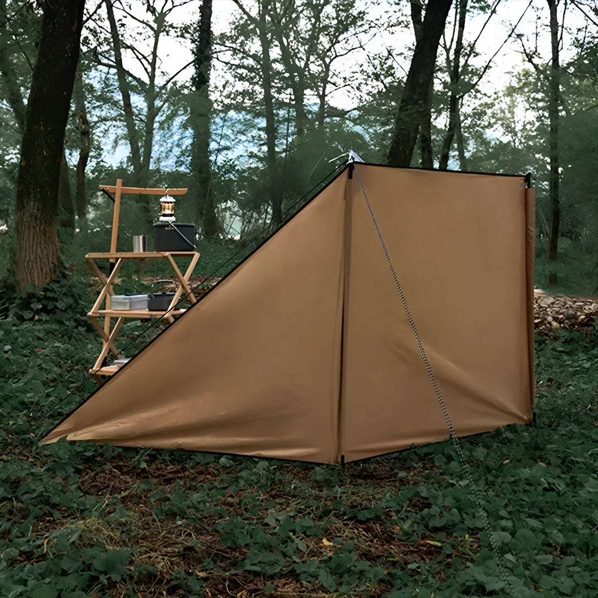 Oxford cloth camping windshield tent in Army Green with support poles and ground nails for outdoor stove cooking