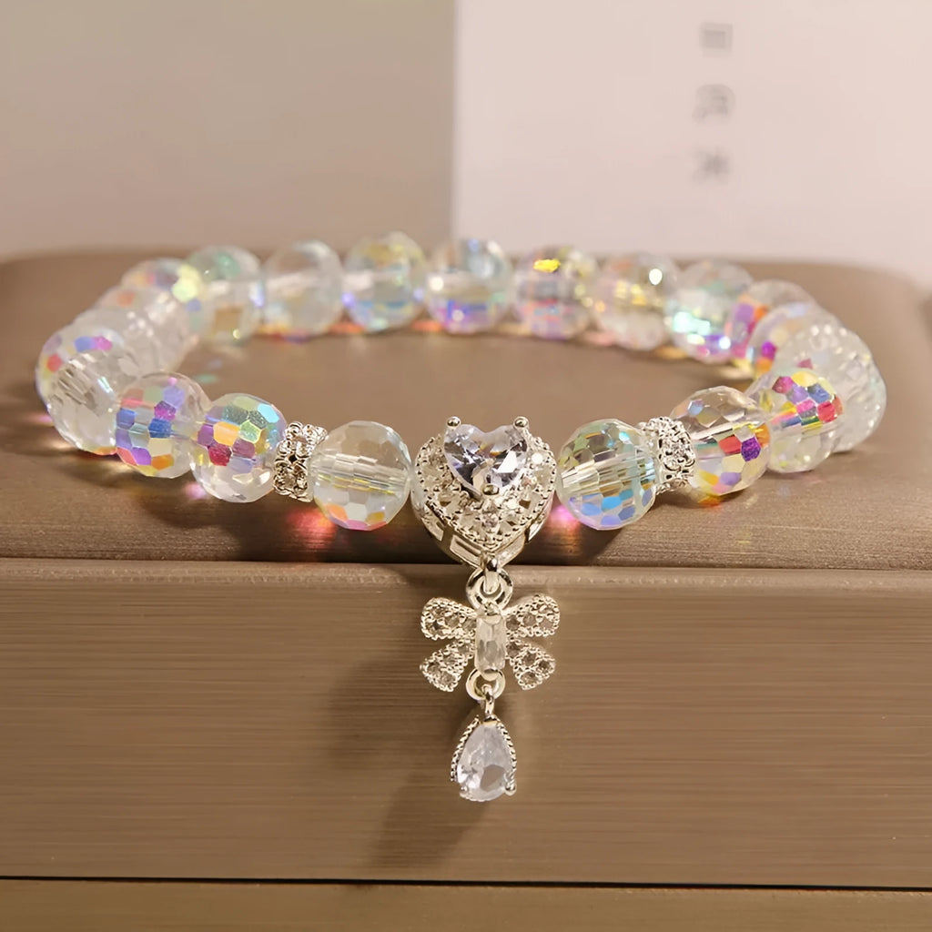 White crystal women's bracelet with butterfly and water drop charms on a metal chain, Japanese Korean style snowflake element.