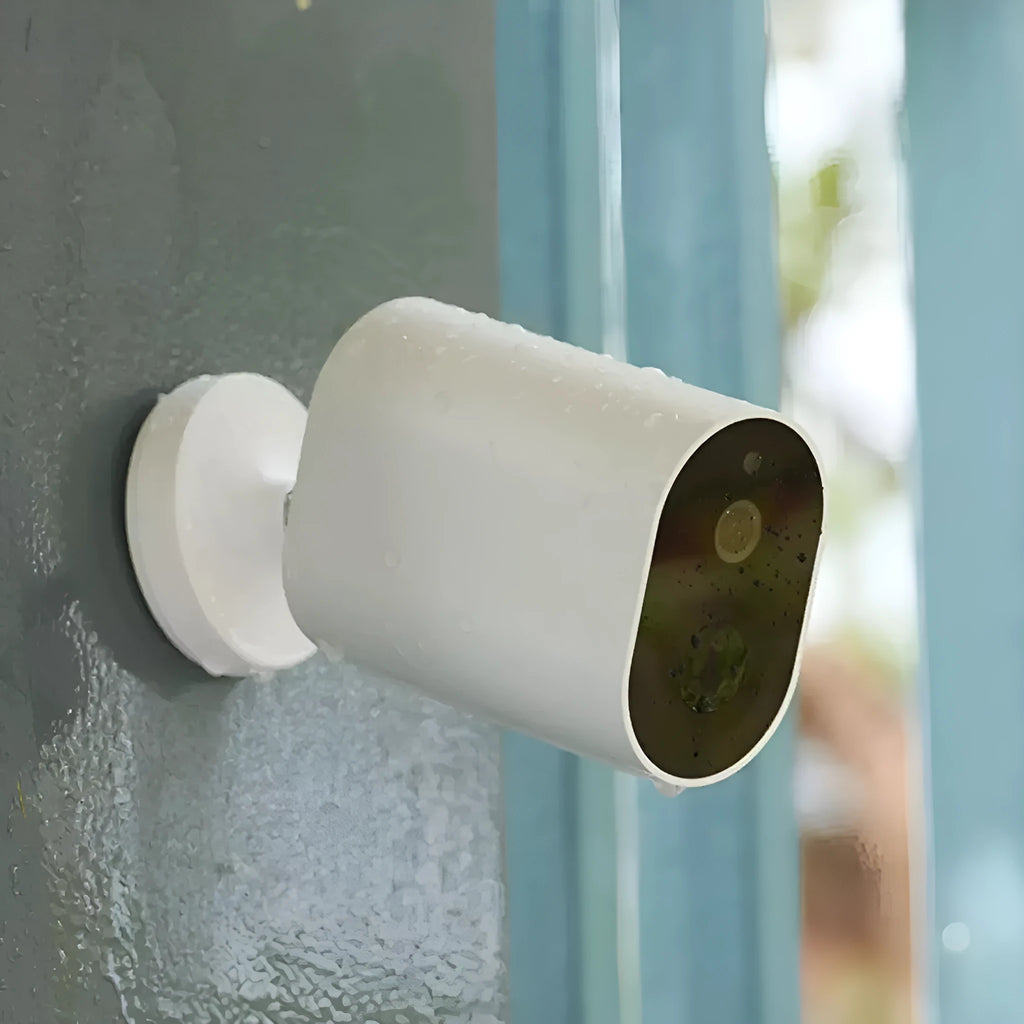 White wireless battery-powered security camera with 5100mAh, 120° view, and voice intercom on wall bracket