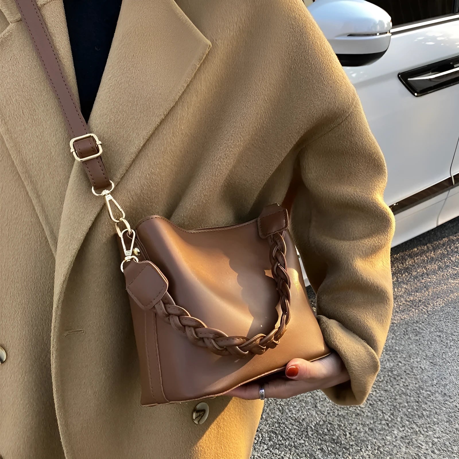 Woven pattern PU leather crossbody bucket bag worn underarm, shown in khaki colour.