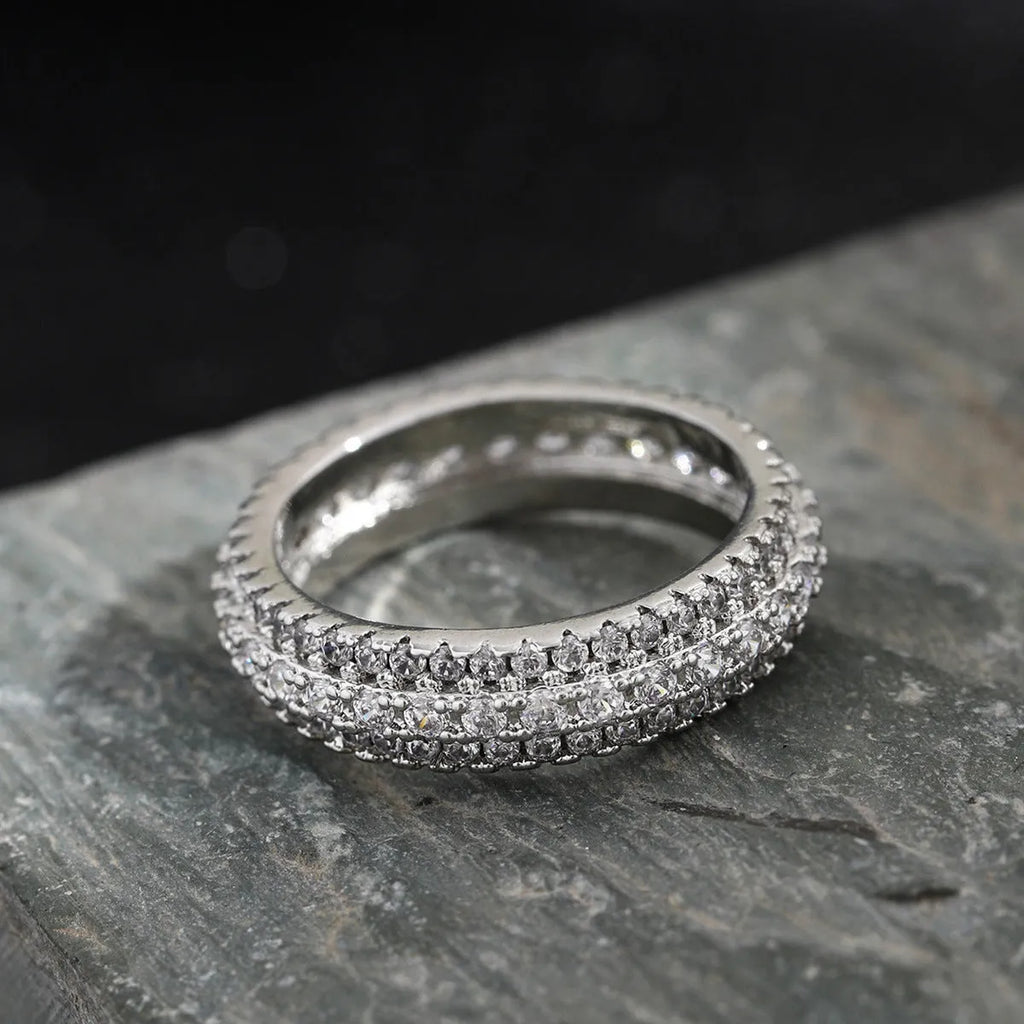 A geometric copper ring with a triangular zircon stone inlay, shown in a white gold colour finish.