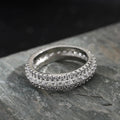 A geometric copper ring with a triangular zircon stone inlay, shown in a white gold colour finish.