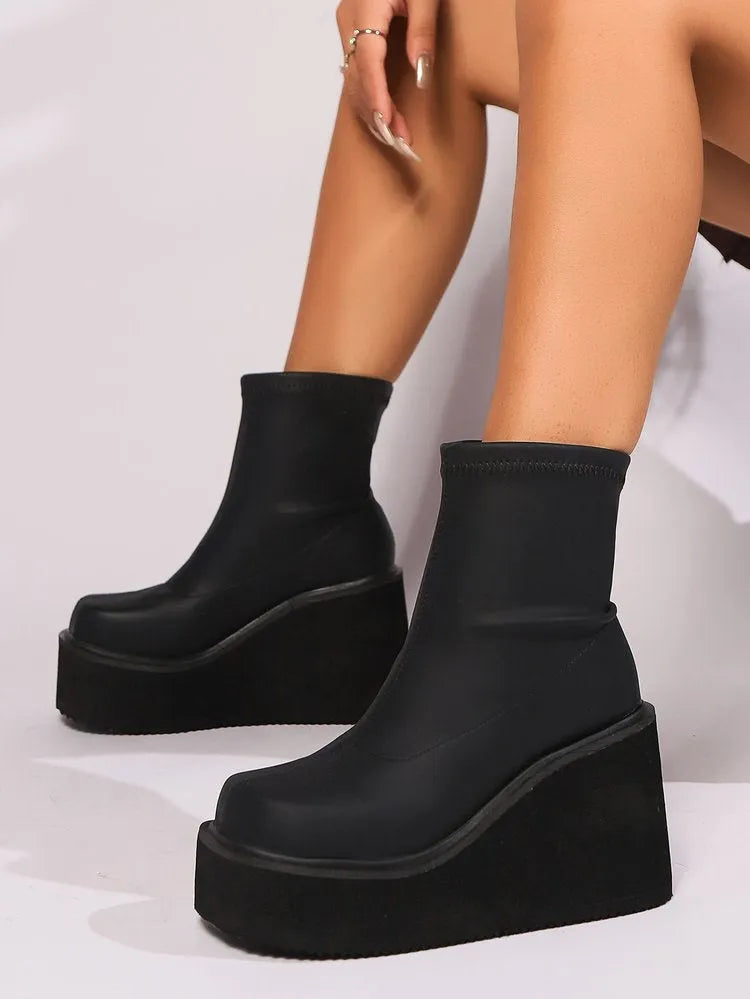 Plus size black wedge heel boots with a waterproof platform and high cylinder design.