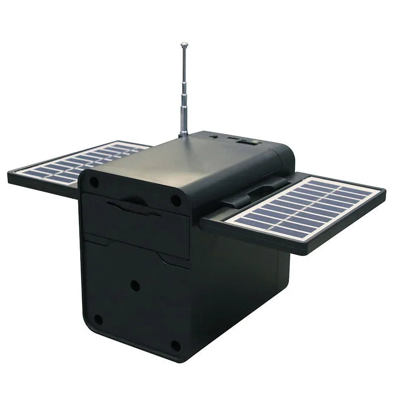 Black plastic solar emergency FM radio with USB charging port and built-in speaker, 10.5x11.5x9.5 cm