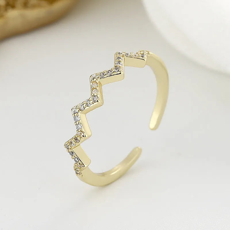 ECG Wave V-shaped zircon ring in gold colour on white background