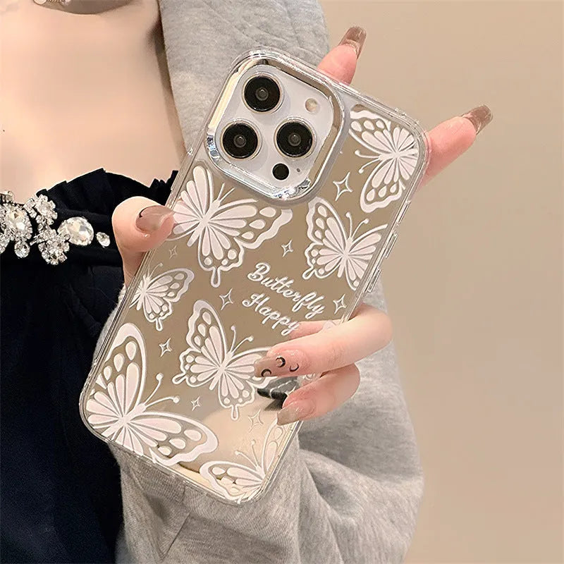 Transparent iPhone case with a built-in round mirror and a painted pink bow decoration on the back.