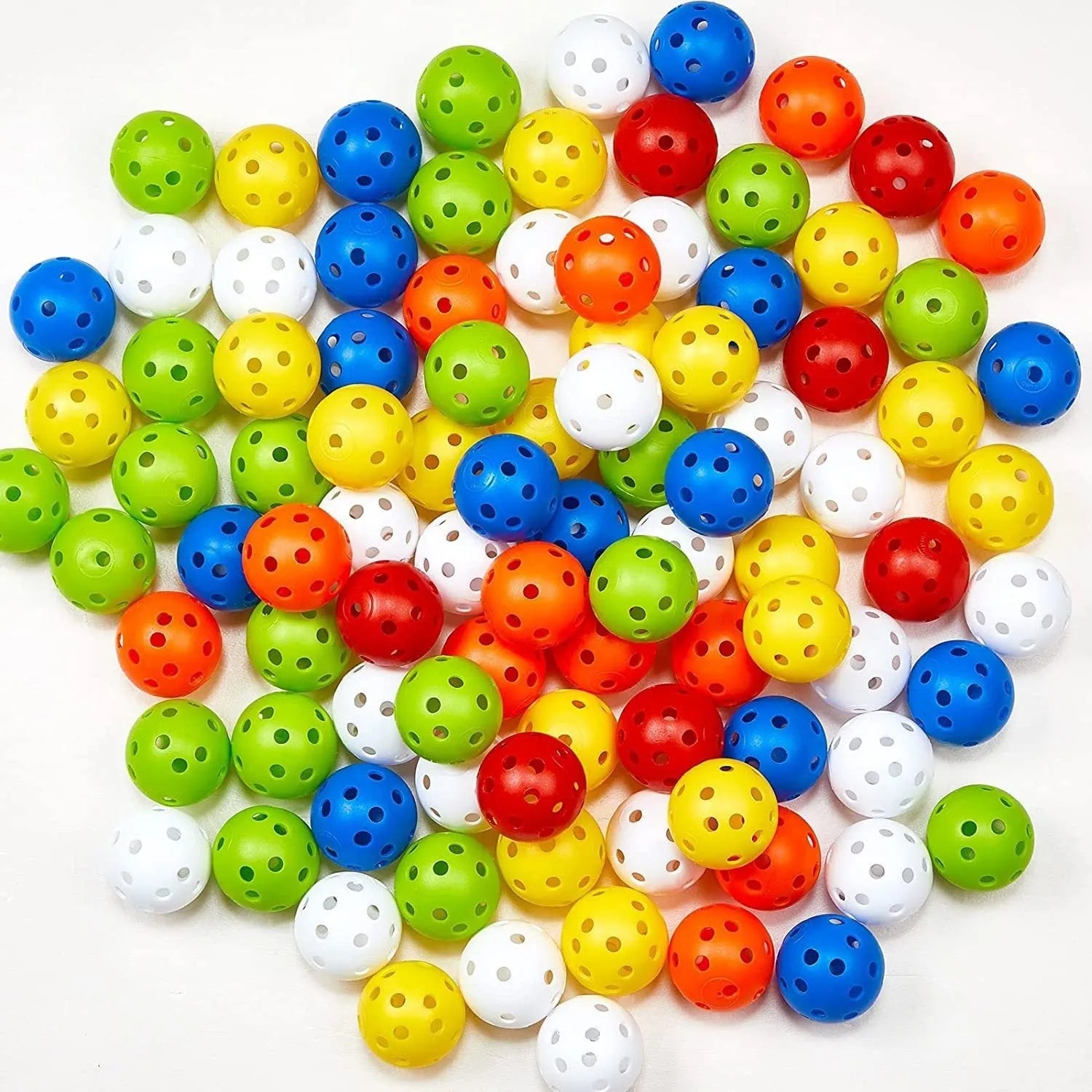 Assorted multi-colour 42mm golf practice balls with a net bag, shown next to practice putting holes.