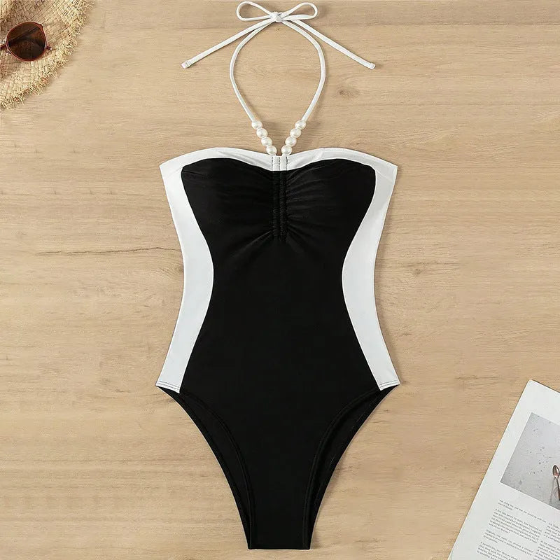 Black and white women's one-piece swimsuit with pearl spaghetti straps, slim fit for swimming.