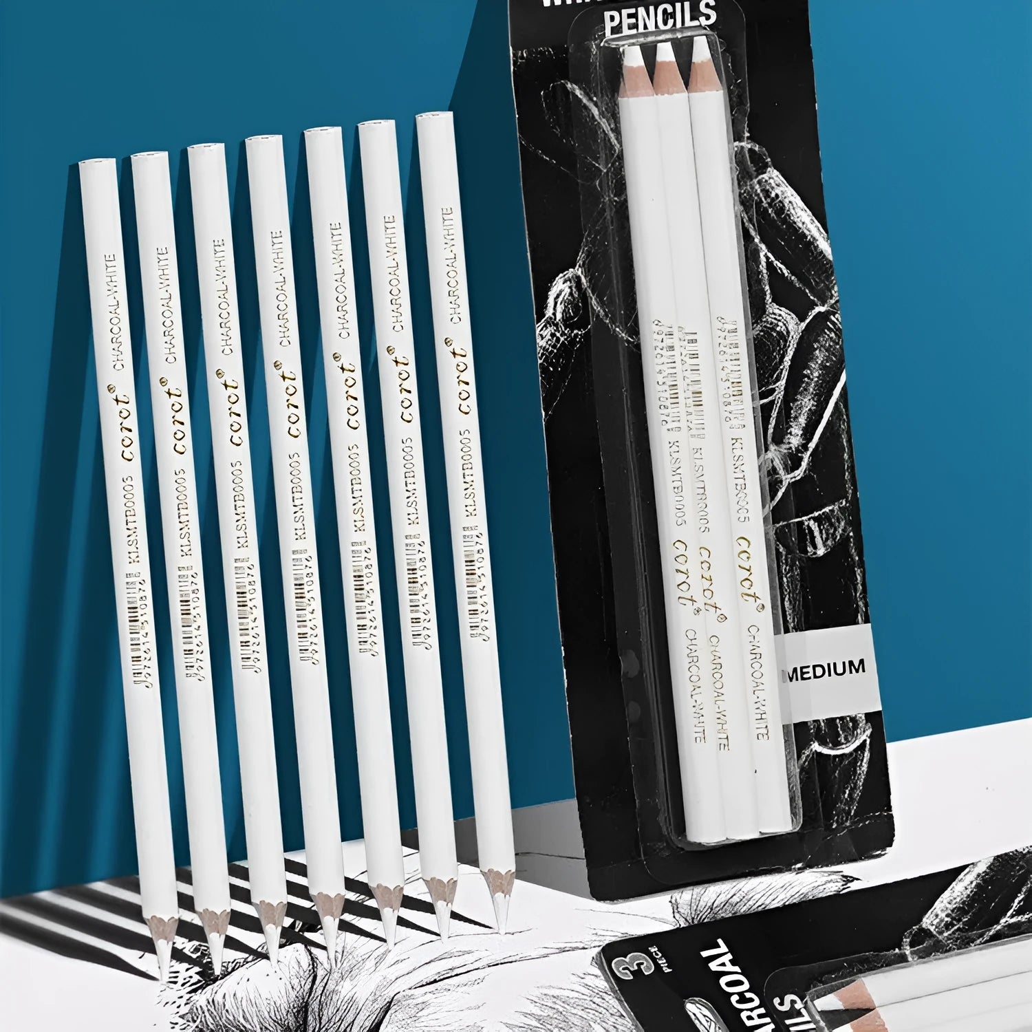 Set of three white charcoal pencils in wooden barrels for sketching on dark paper