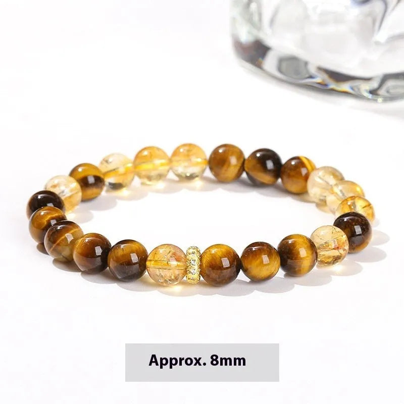 Close-up of a women's yellow tiger-eye stone and crystal bracelet with 8mm round beads.