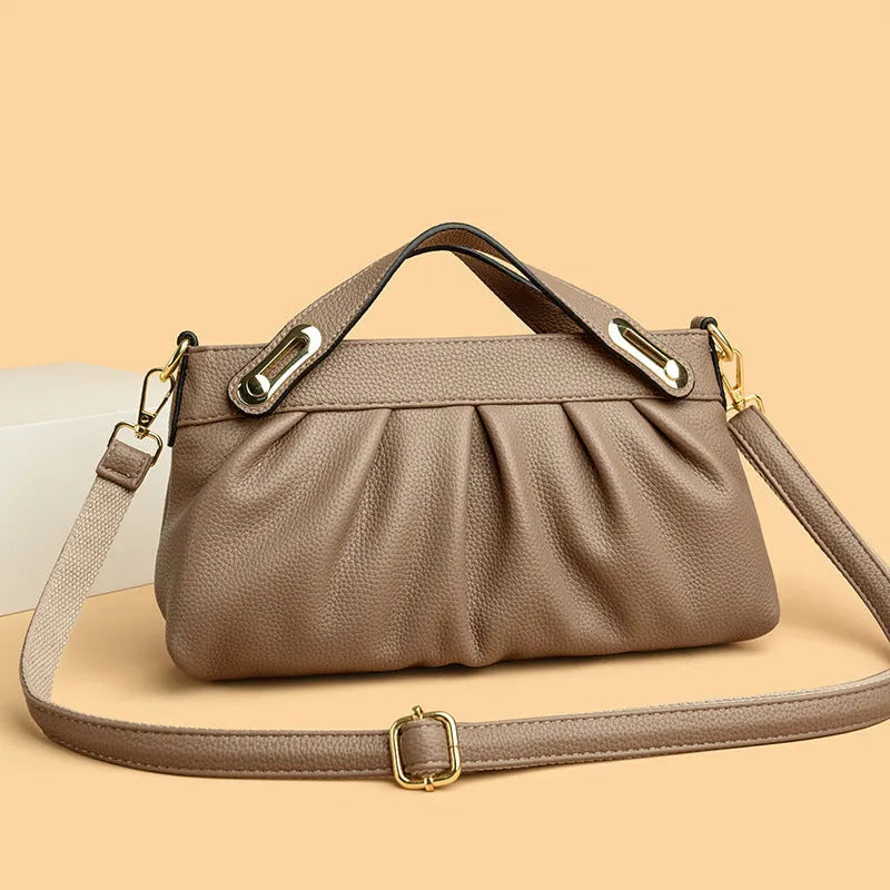Genuine leather crossbody bag with pleated shoulder strap and wrinkled composite leather finish in horizontal square shape