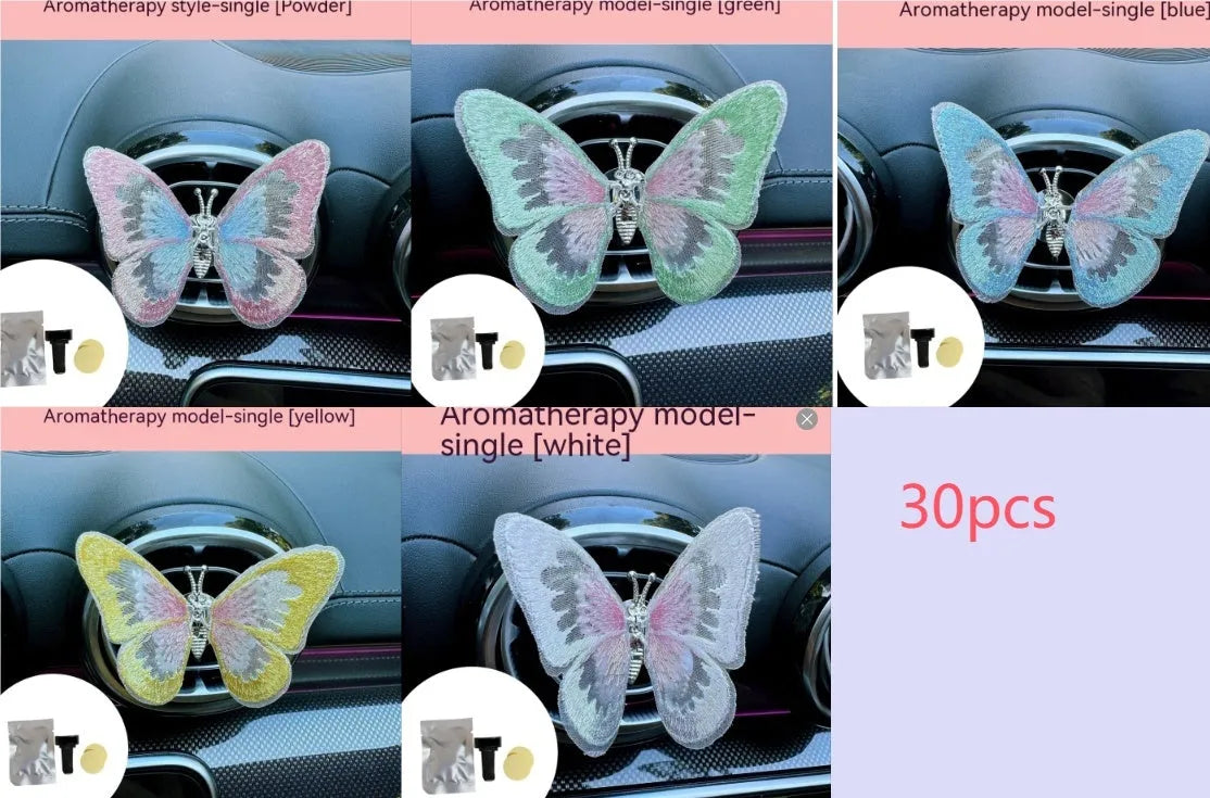 Soft fabric embroidered butterfly car air vent decoration in multiple colour options on a centre console.