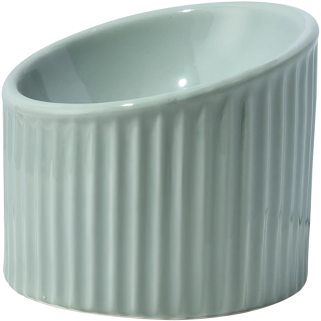 Dark green ceramic elevated cat bowl with tilted design on a raised platform.