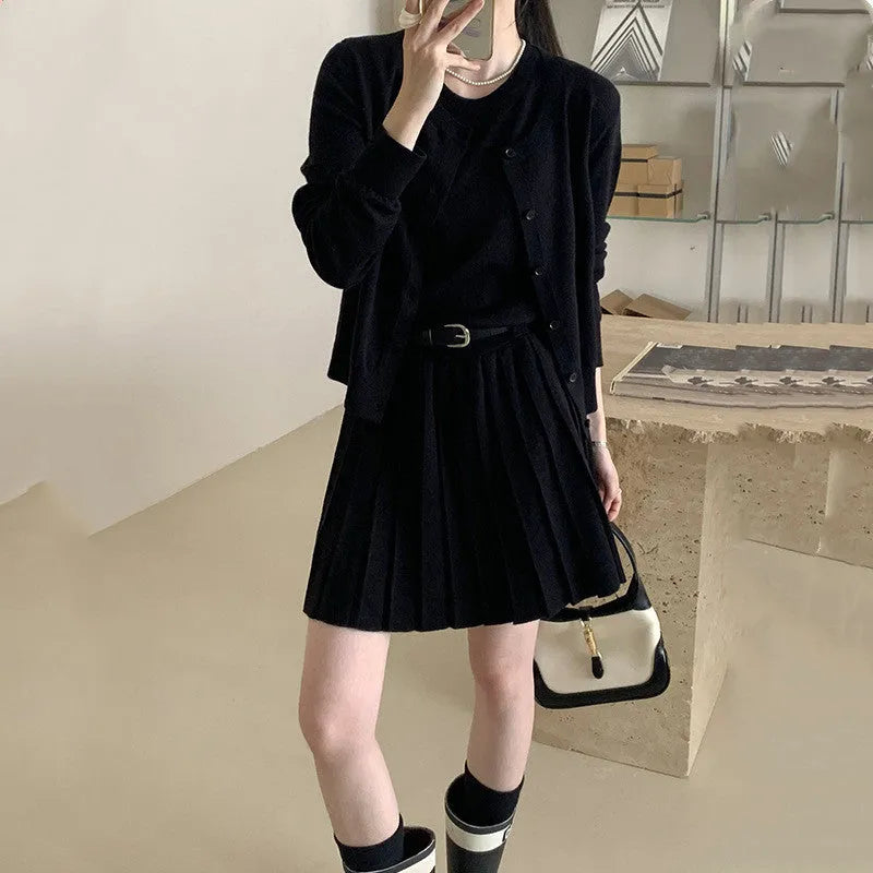 Grey knitted two-piece set with 3D pattern, featuring a belted vest skirt and long-sleeve cardigan.
