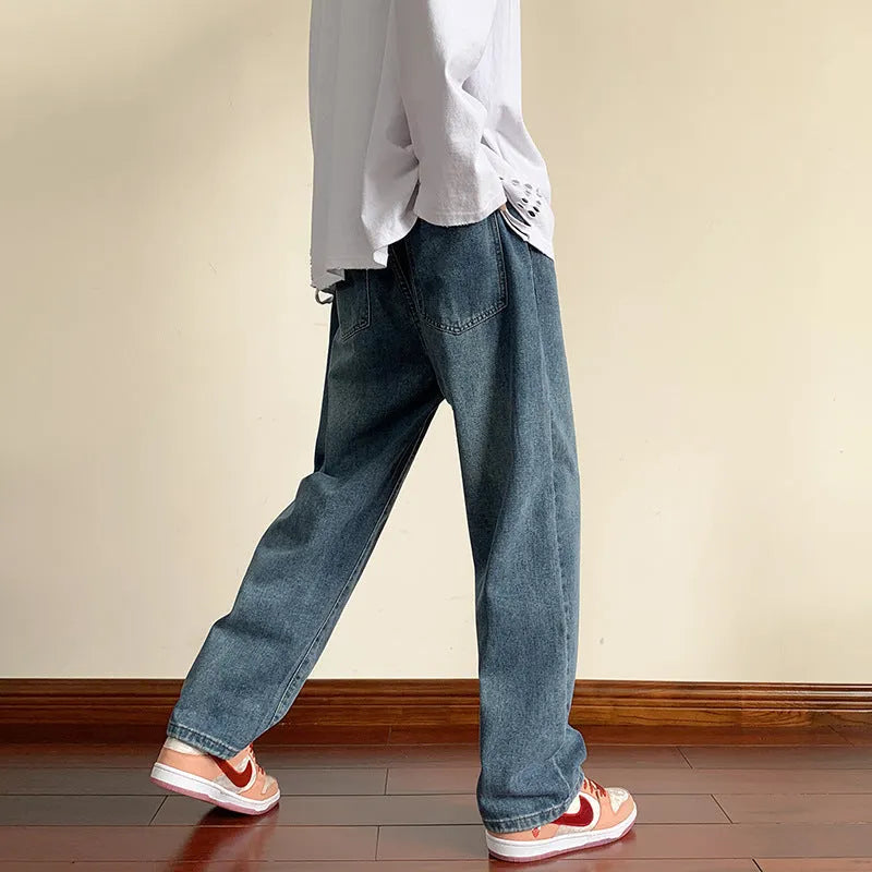 Men's loose cotton sports jeans in retro blue with zipper fly, side view on model