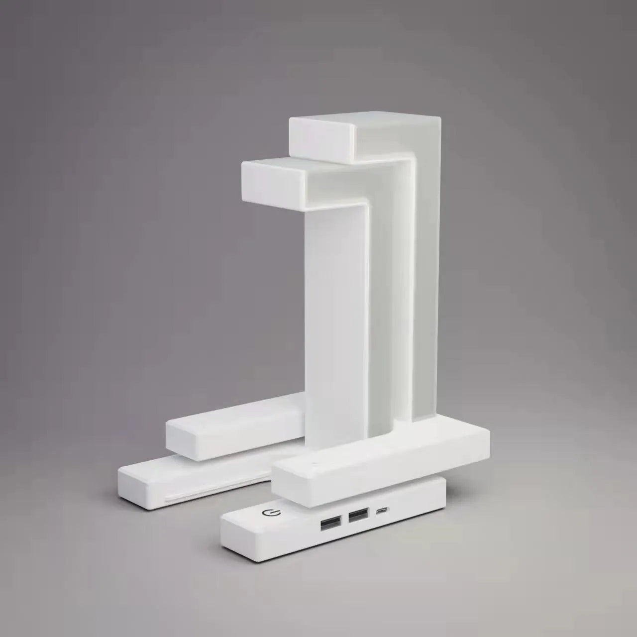 White magnetic suspension table lamp with wireless charging base, floating shade, and foldable bracket on a desk