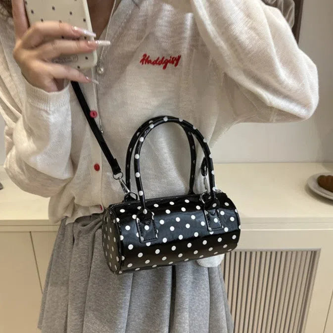 Korean-style PU leather tote pillow bag in black, white, and red colours, cylindrical shape with stitched seams and single shoulder strap, 20x10x10cm